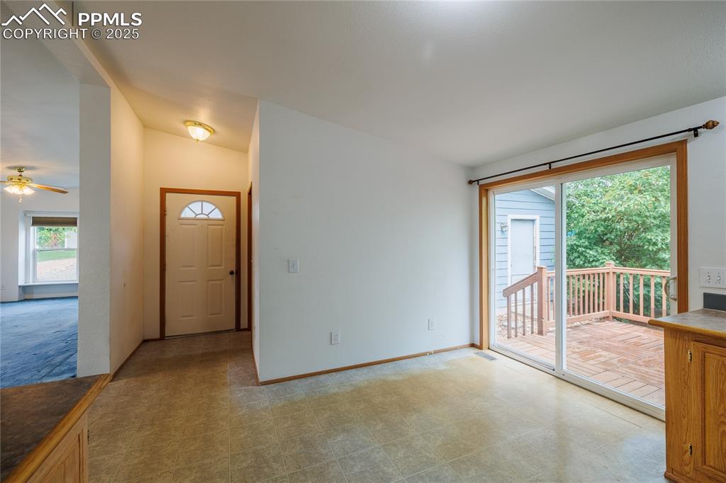 Image 6 of 26: Entryway with tile patterned floors, a ceiling fan, and baseboards