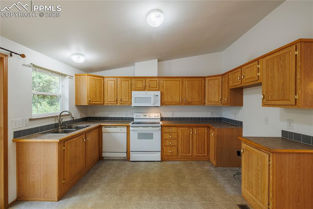 Image 9 of 26: Kitchen with white appliances