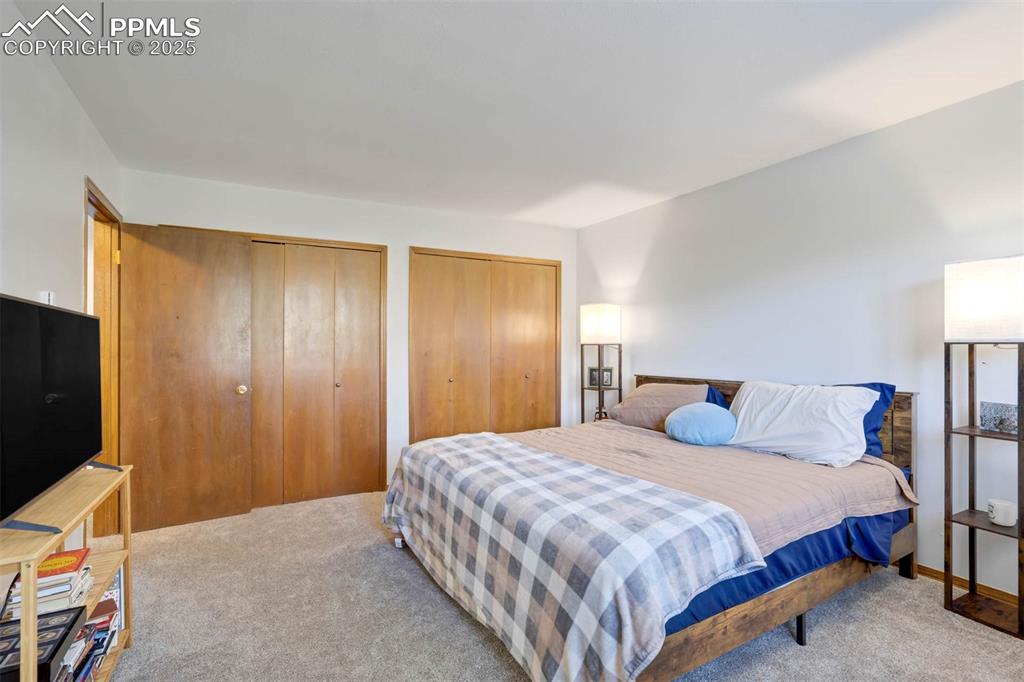 Image 18 of 35: Bedroom with multiple closets flooring