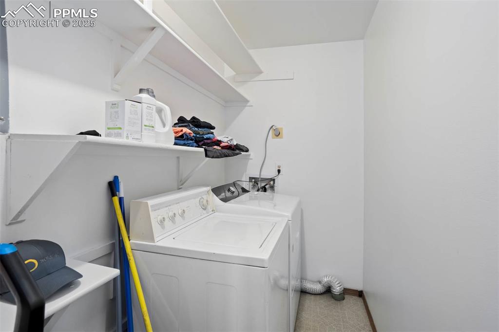 Image 24 of 35: Laundry room with washer and dryer and baseboards