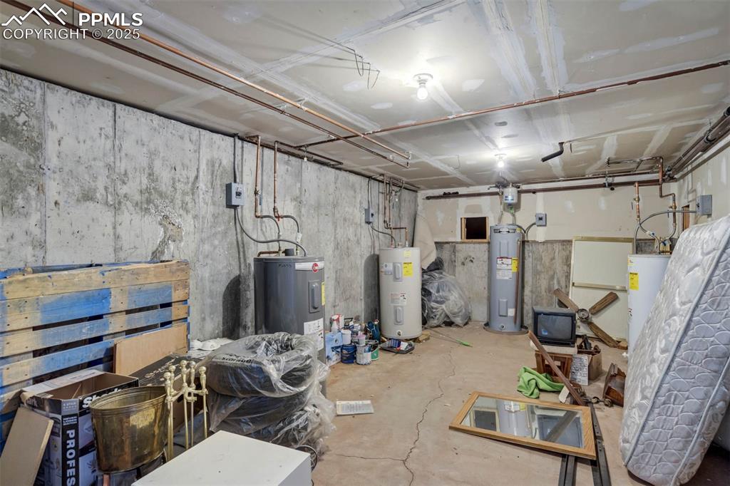 Image 26 of 35: Unfinished basement featuring water heater
