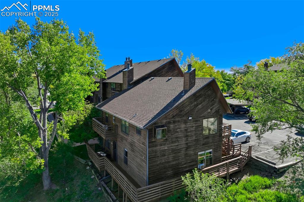 Image 27 of 35: View of side of property featuring a chimney