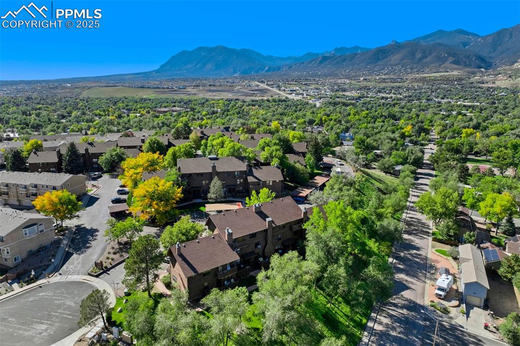 Image 30 of 35: Aerial view of residential area with a mountain backdrop