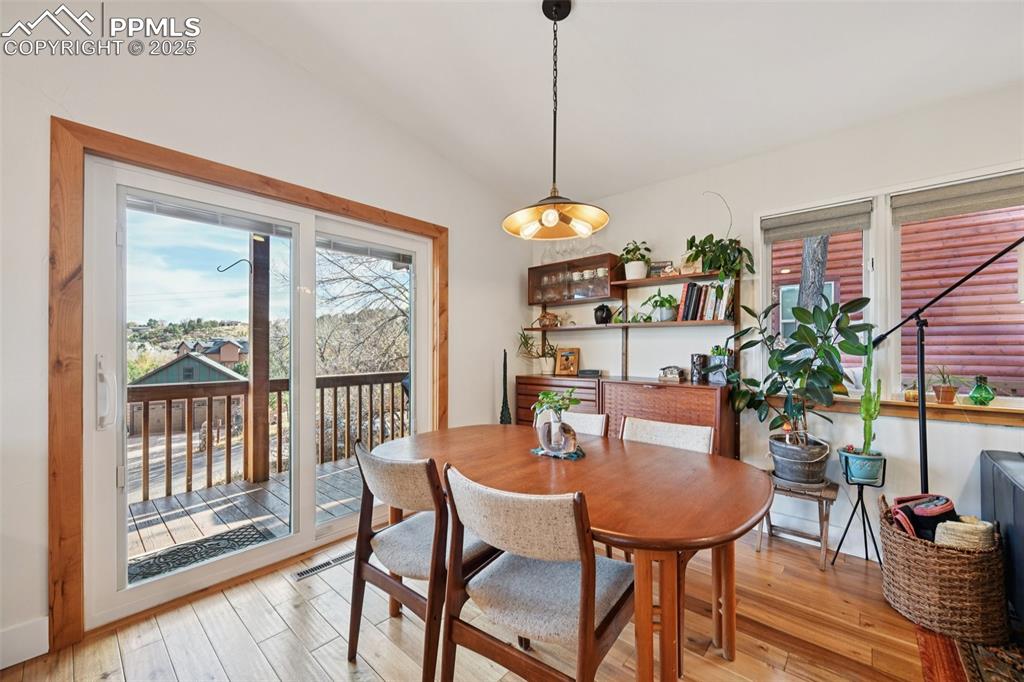 Image 10 of 42: Dining room with walk out to wrap around deck
