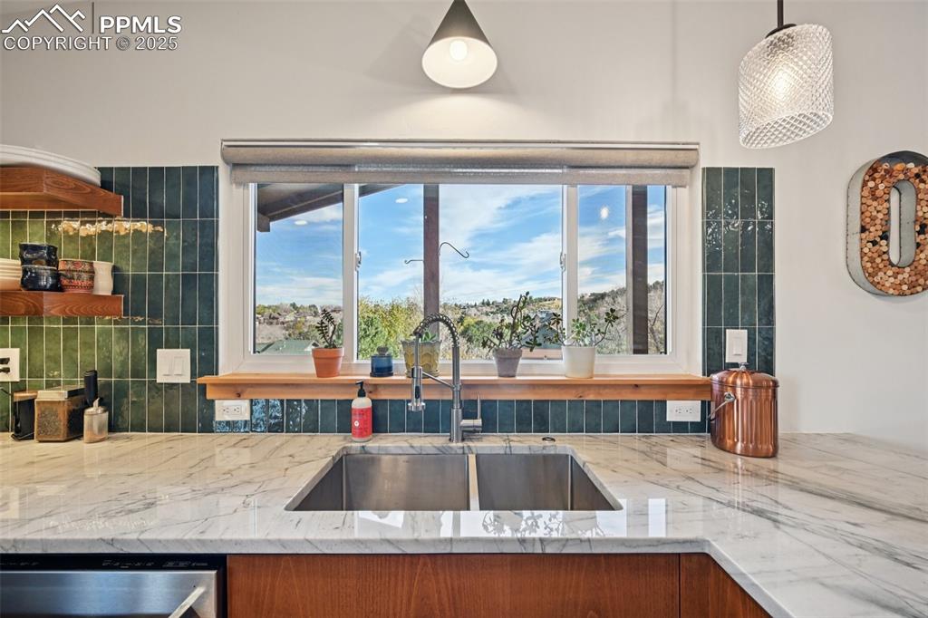Image 15 of 42: Kitchen with gas burning stove, custom cabinetry, wine fridge, quartzite co