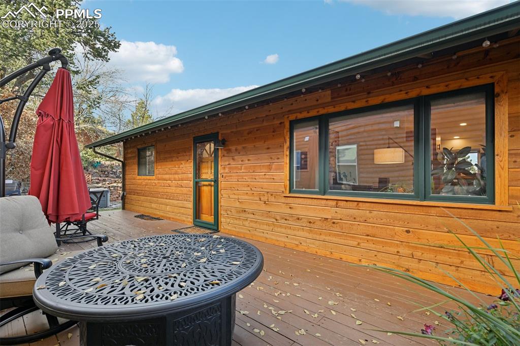 Image 4 of 42: Wrap around deck leading to the front door