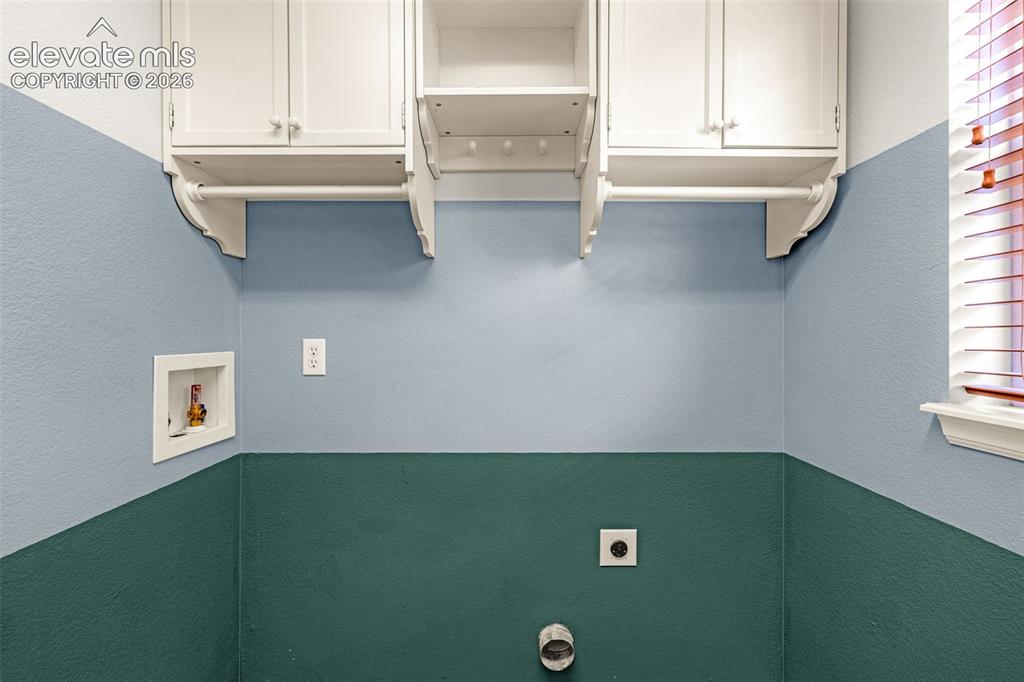Image 32 of 44: Overhead cabinets in the laundry room