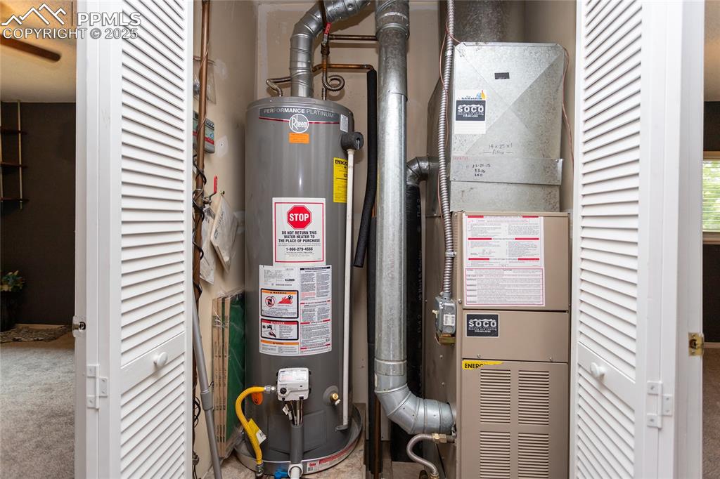 Image 12 of 50: Utility room with gas water heater