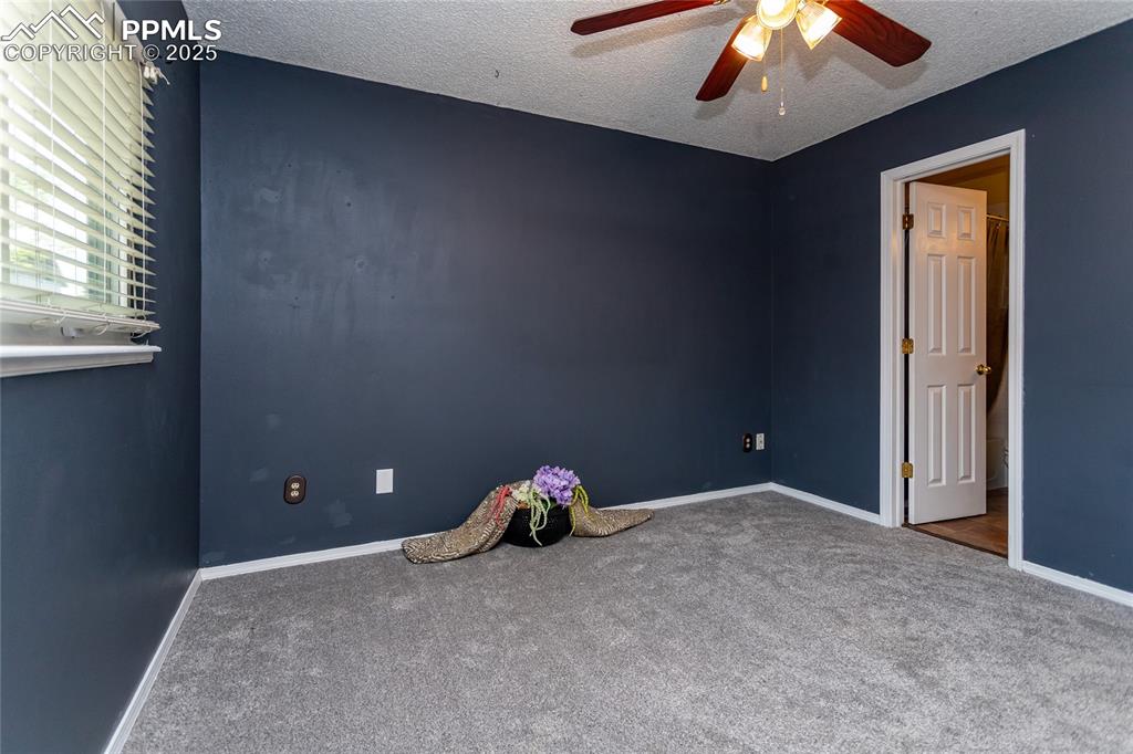 Image 17 of 50: Unfurnished bedroom with carpet floors, a textured ceiling, baseboards, and