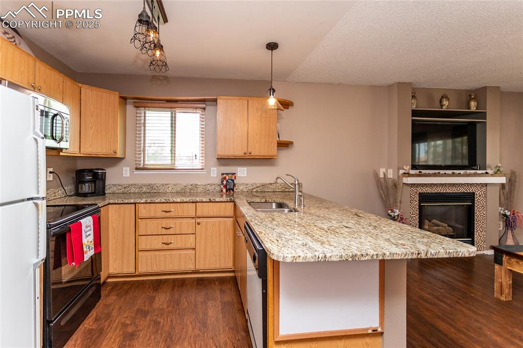 Image 32 of 50: Kitchen featuring appliances with stainless steel finishes, light brown cab