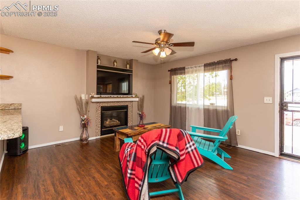 Image 35 of 50: Living area featuring wood finished floors, plenty of natural light, ceilin