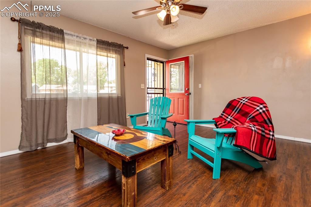 Image 38 of 50: Sitting room featuring ceiling fan, wood finished floors, baseboards, and a