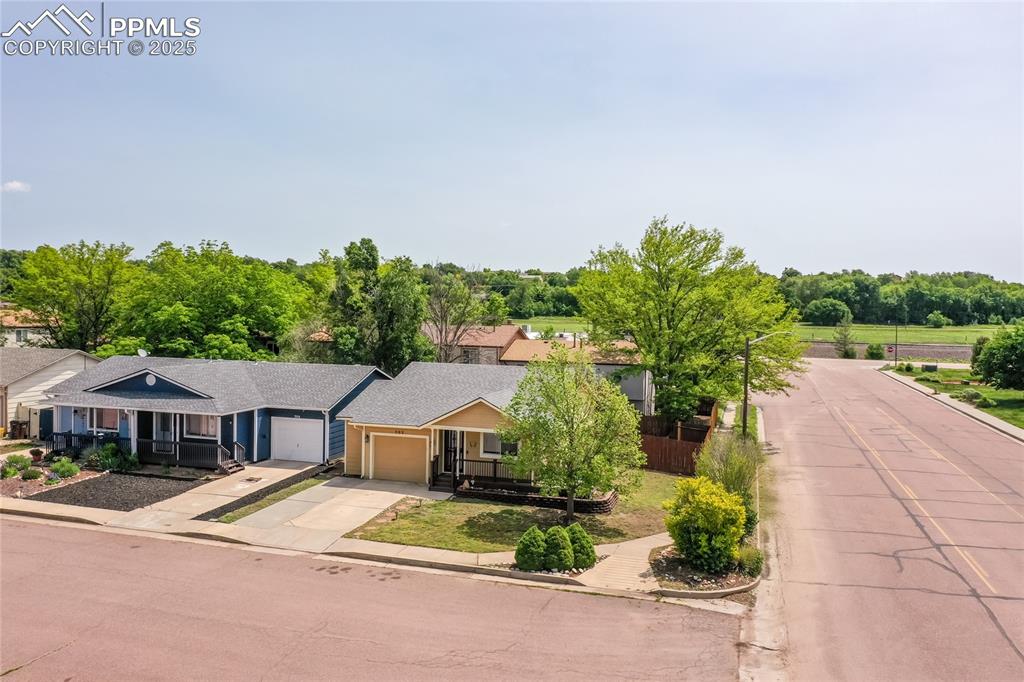 Image 4 of 50: View of front of home with concrete driveway, an attached garage, and roof