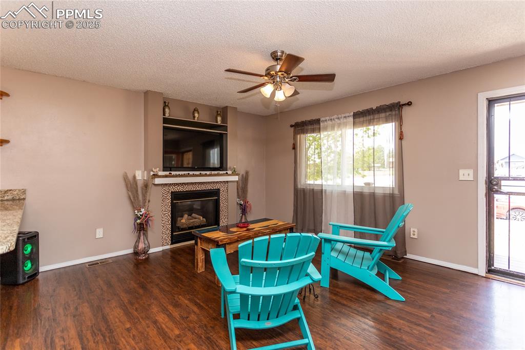 Image 44 of 50: Sitting room featuring wood finished floors, ceiling fan, healthy amount of