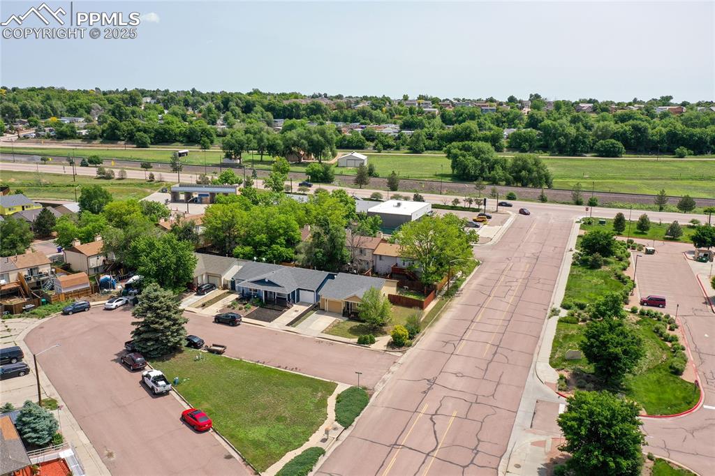Image 7 of 50: Aerial view of residential area featuring a tree filled landscape