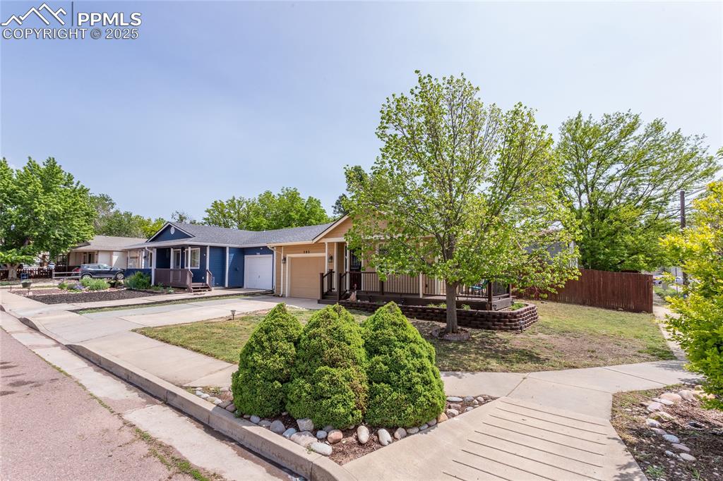 Image 8 of 50: View of front of home with a garage, driveway, and a porch