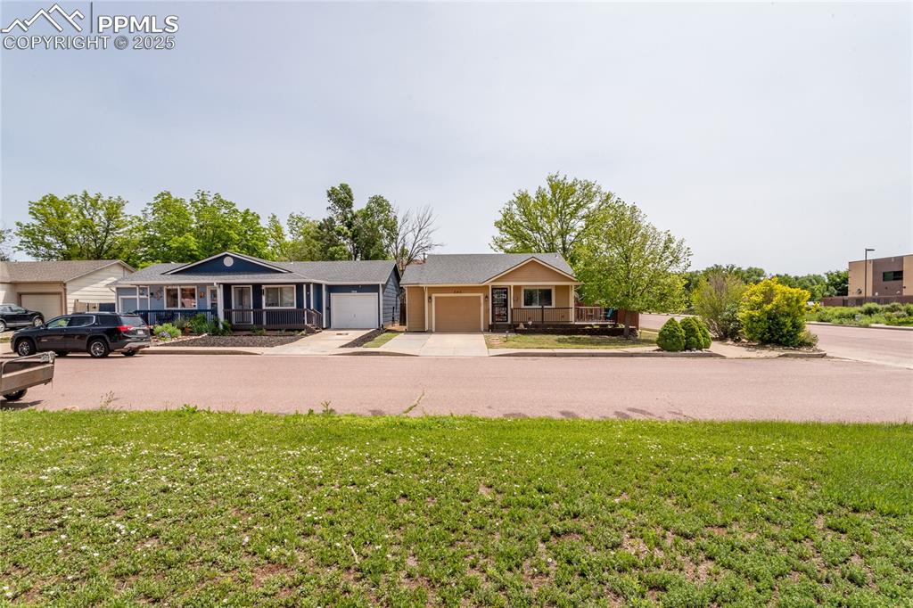Image 9 of 50: Single story home featuring driveway, a front yard, and a garage
