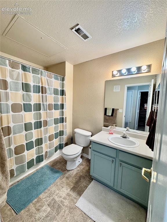 Image 14 of 32: Bathroom featuring a light-colored vanity with a white countertop and integ