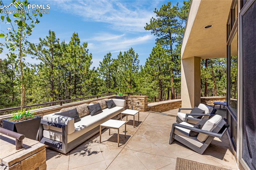 Image 12 of 48: Wrap around patio with peaceful views