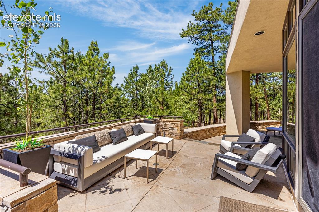 Image 13 of 49: Wrap around patio with peaceful views