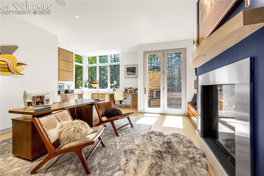 Image 19 of 48: Office with fireplace & walk-out