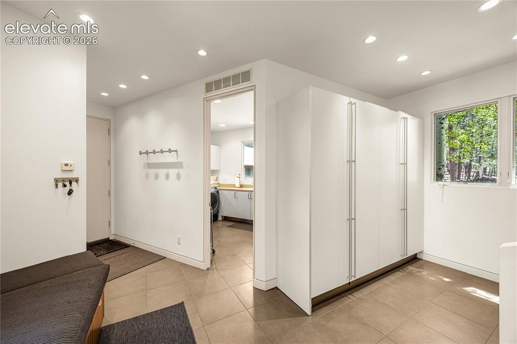 Image 24 of 49: Mudroom connects laundry room to garage