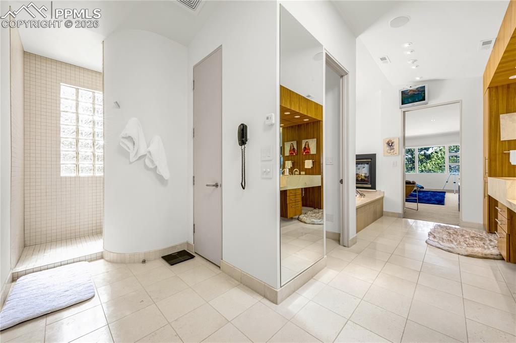 Image 32 of 48: Walk-in primary closet with built-in organization