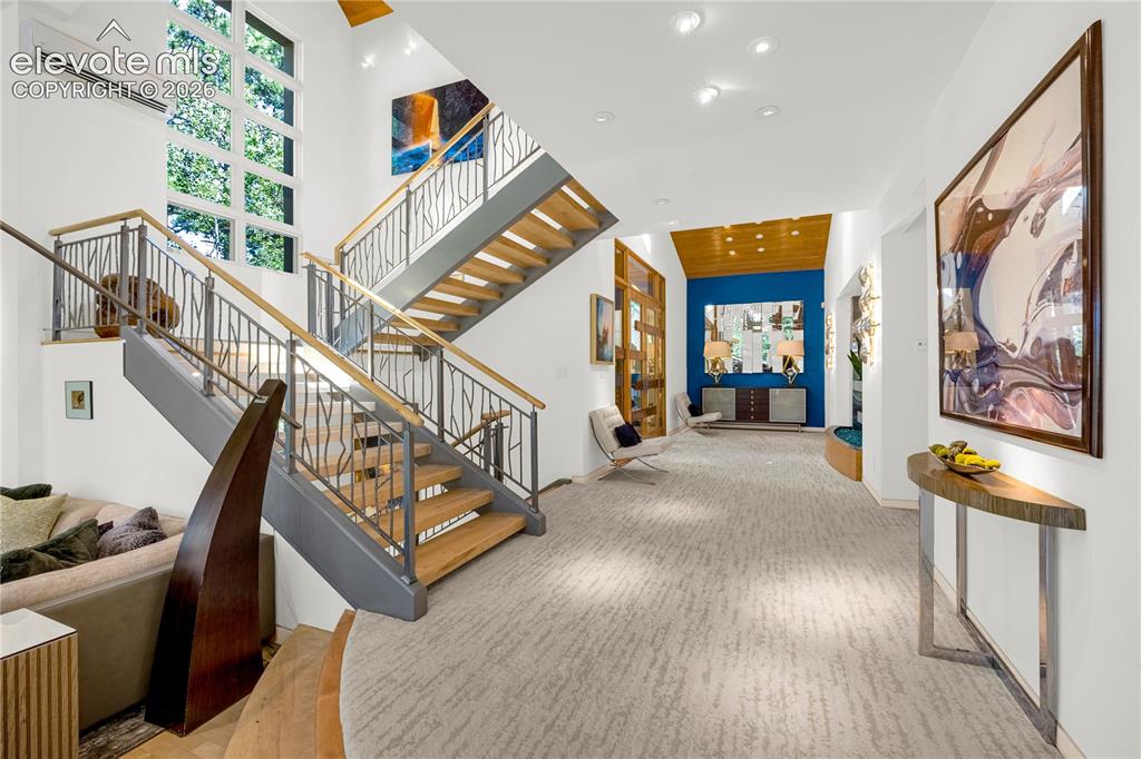 Image 7 of 49: Entryway & custom staircase