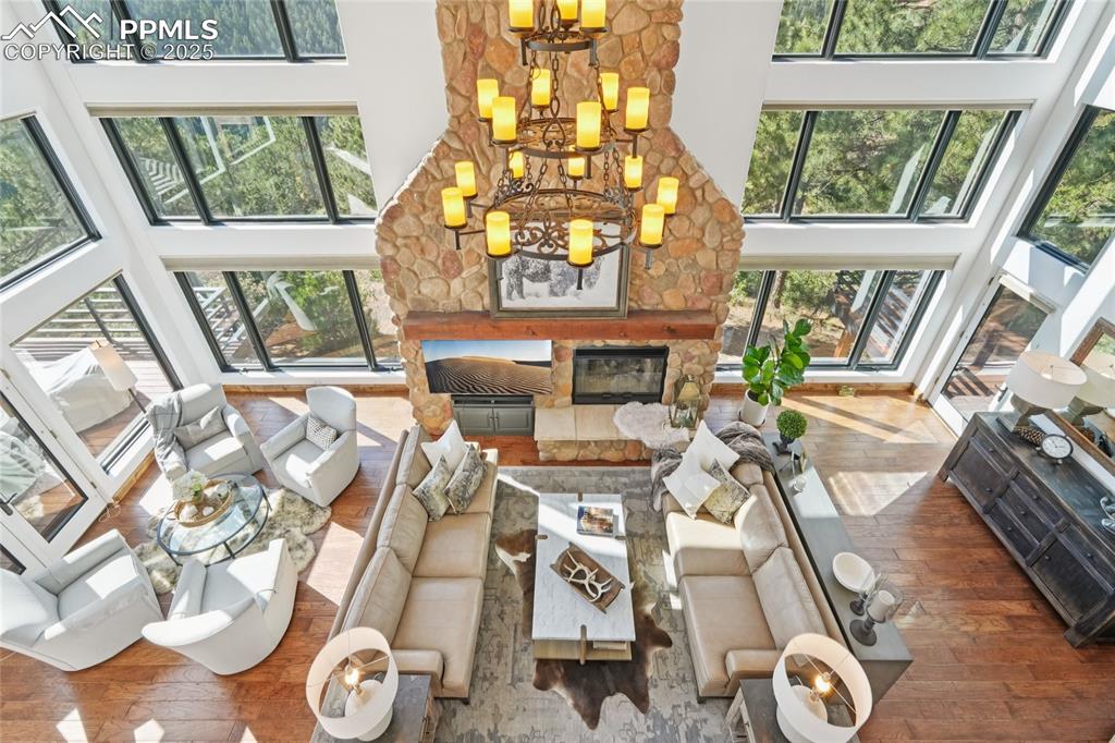 Image 10 of 50: View of the living room with gas fireplace surrounded by a stone mantle fro