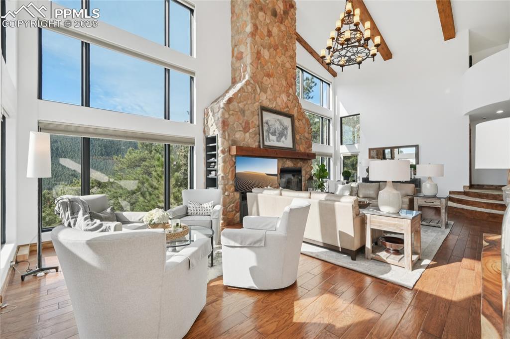 Image 11 of 50: Living room with tons of natural light, oak flooring with two walk outs and