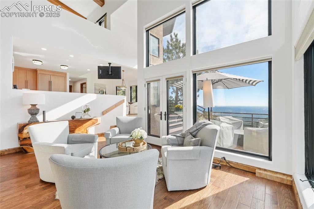 Image 12 of 50: Sitting area in the living room with a walk out to deck