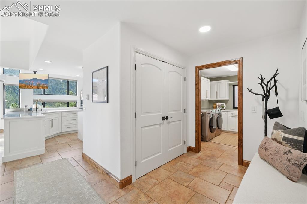 Image 18 of 50: Hallway which has pantry, laundry and half bathroom