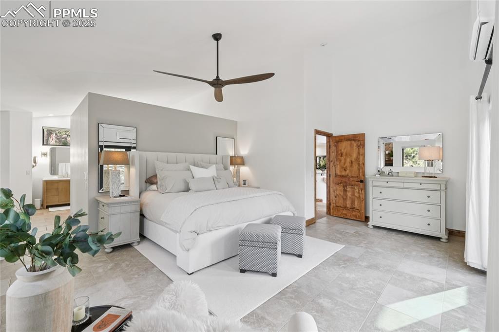 Image 22 of 50: Primary bedroom with walk out to private deck and 5 piece en suite bathroom