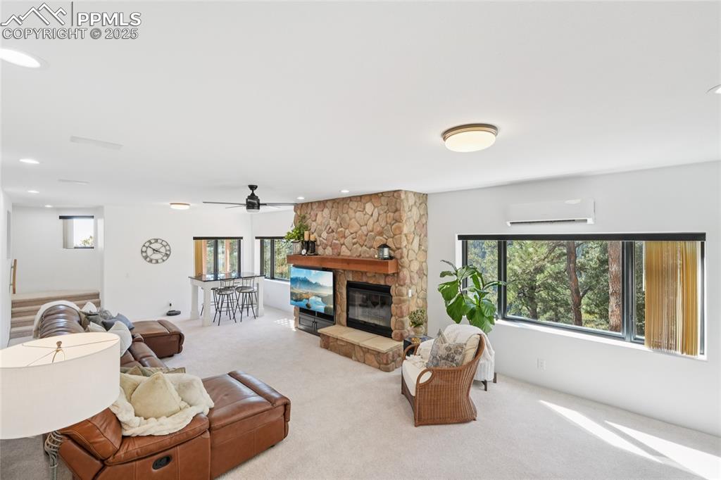 Image 31 of 50: Recreation room on lower level with gas burning fireplace and walk out to p