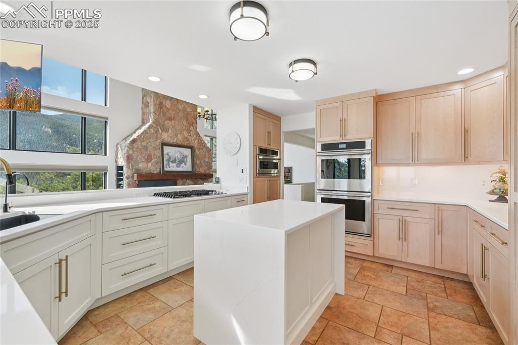 Image 6 of 50: Newly updated kitchen with island looking to the living room