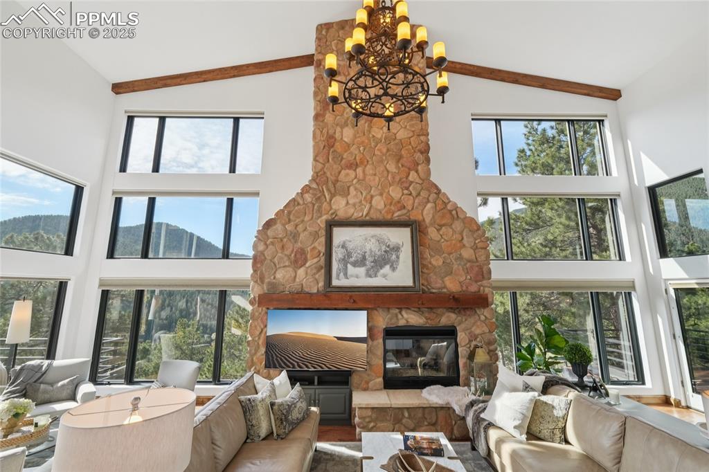 Image 9 of 50: Naturally lit and spacious living room with views of the mountains just out