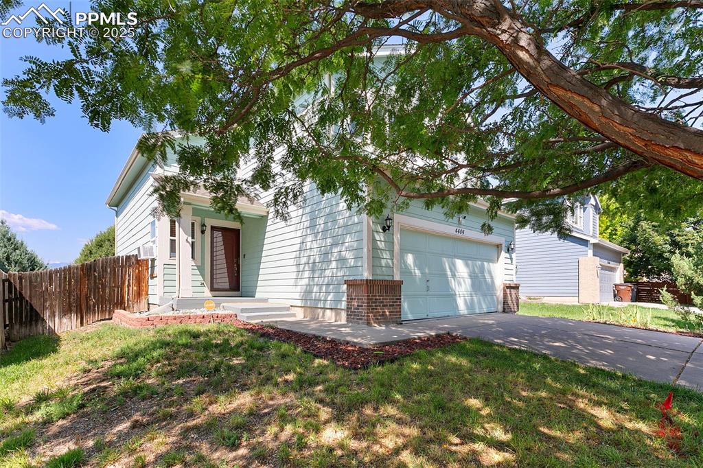Caption: Front of house featuring mature tree and front entry
