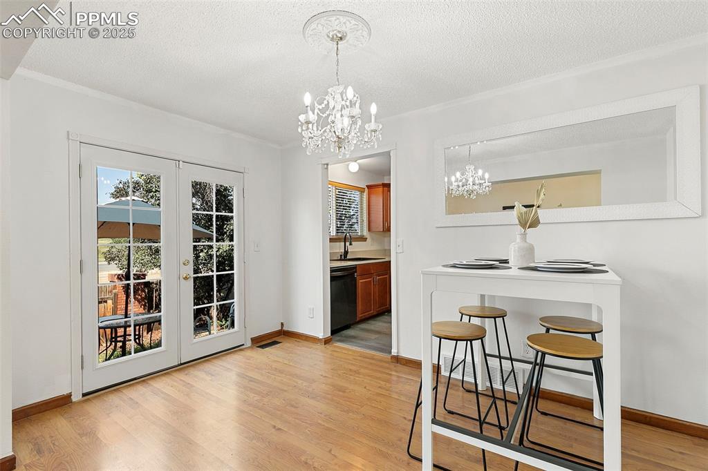 Image 10 of 29: Dining area with kitchen access and french doors to back patio