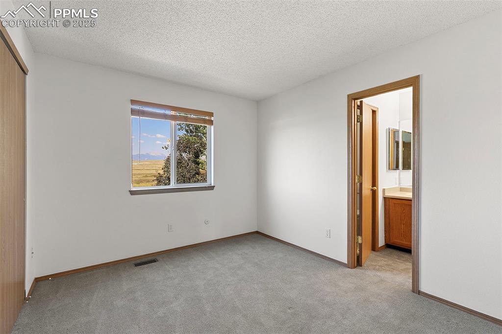 Image 20 of 29: Upstairs bedroom with access to jack-and-jill bathroom