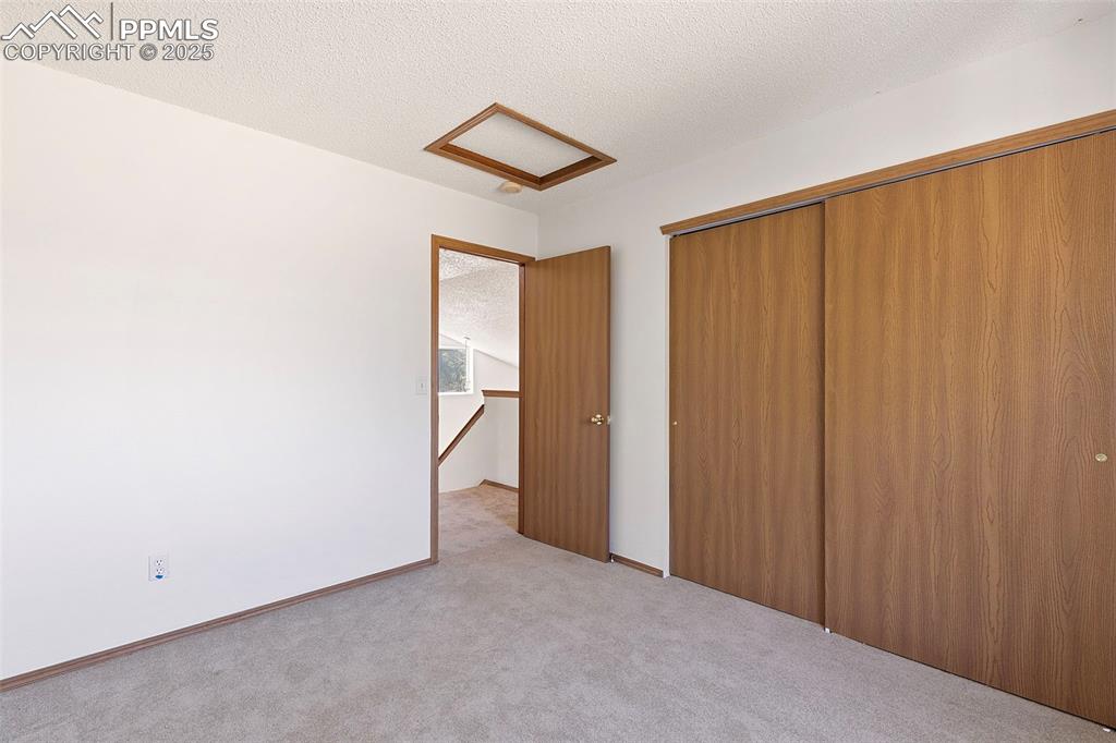 Image 21 of 29: Upstairs bedroom featuring new carpet and paint