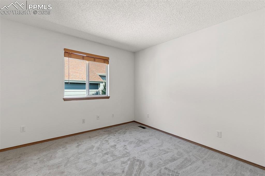 Image 22 of 29: Additional upstairs bedroom featuring new carpet and paint