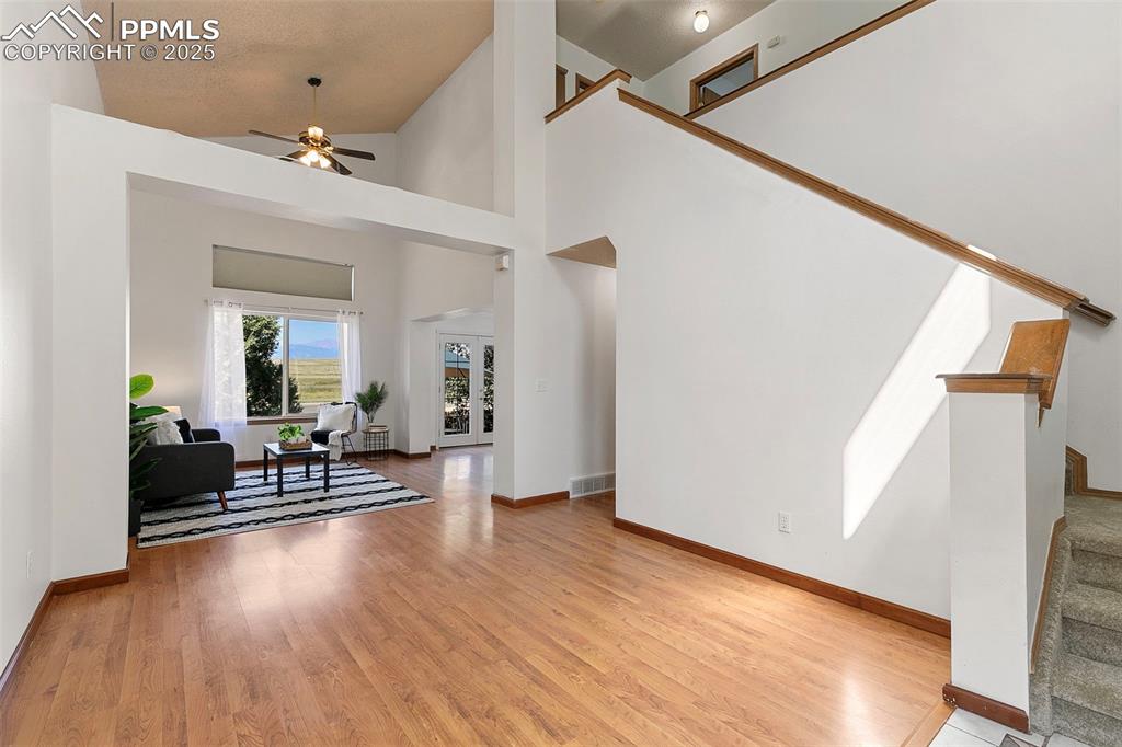 Image 4 of 29: Living Room featuring vaulted ceiling