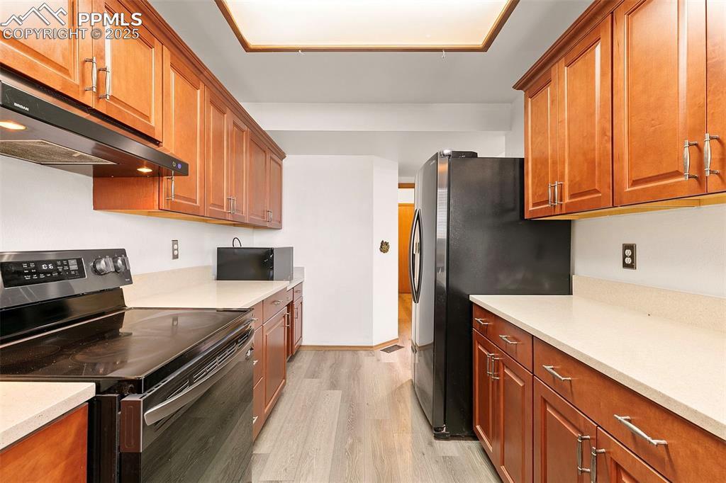 Image 7 of 29: Updated kitchen featuring black stainless appliances
