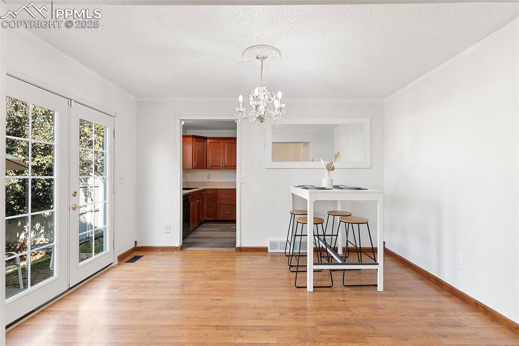 Image 9 of 29: Dining area with kitchen access and french doors to back patio