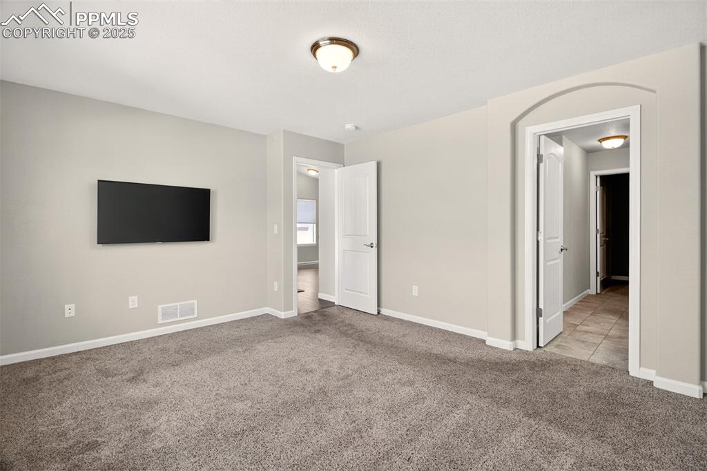Image 12 of 39: Primary bedroom with en suite bathroom