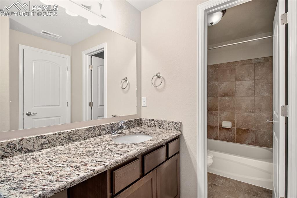 Image 28 of 39: Full bathroom near lower level bedrooms 