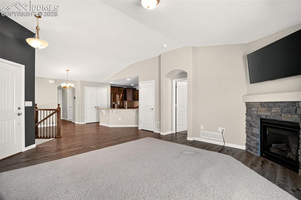 Image 5 of 39: Living room with gas burning fireplace and walk out to fenced backyard