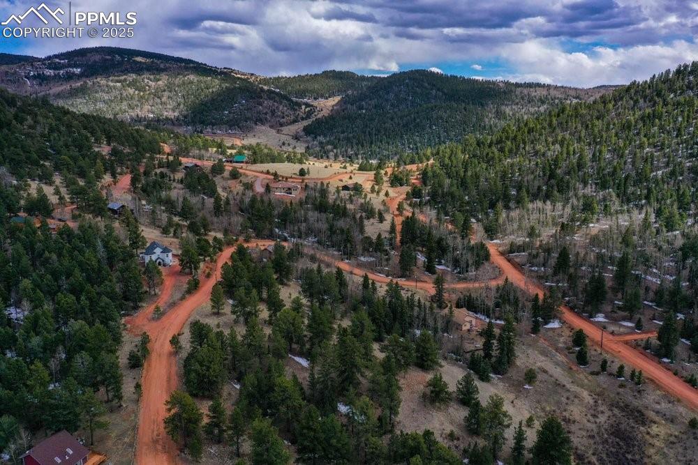 Image 24 of 39: Drone / aerial view featuring a wooded view and a mountain view