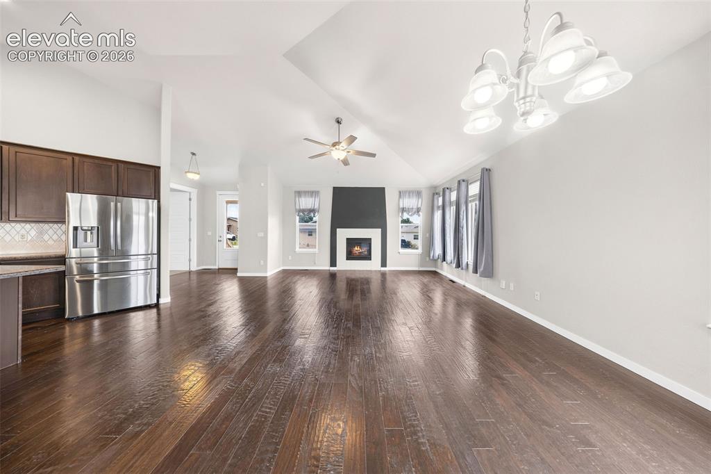 Image 10 of 39: Beautiful kitchen featuring rich dark wood cabinetry, a spacious center isl