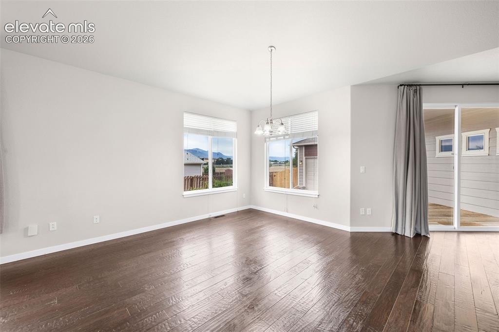 Image 12 of 39: Open-concept kitchen featuring rich dark wood cabinetry, a spacious center 